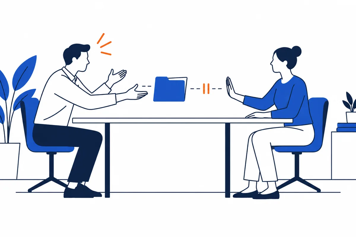 Two seated figures face each other across a table, with a blue rectangular block and small orange marks between them.